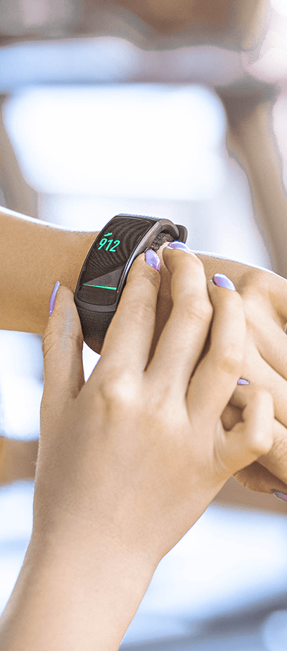 woman adjusting activity and fitness bands