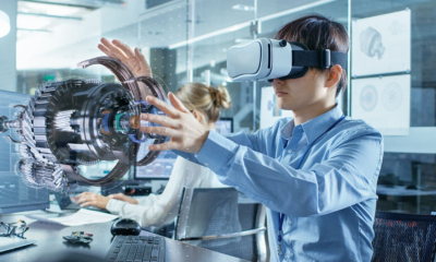 Engineer wearing Virtual Reality Headset Works with 3D Model Hologram Visualization