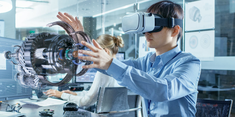 Engineer wearing Virtual Reality Headset Works with 3D Model Hologram Visualization