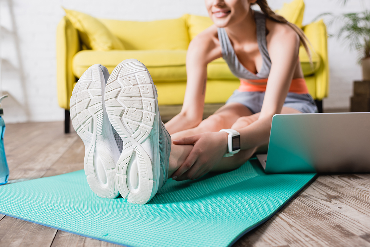 lady working out from home while wearing smartwatch