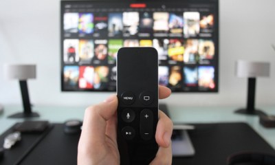 hand holding smart remote controller used to stream movies and shows