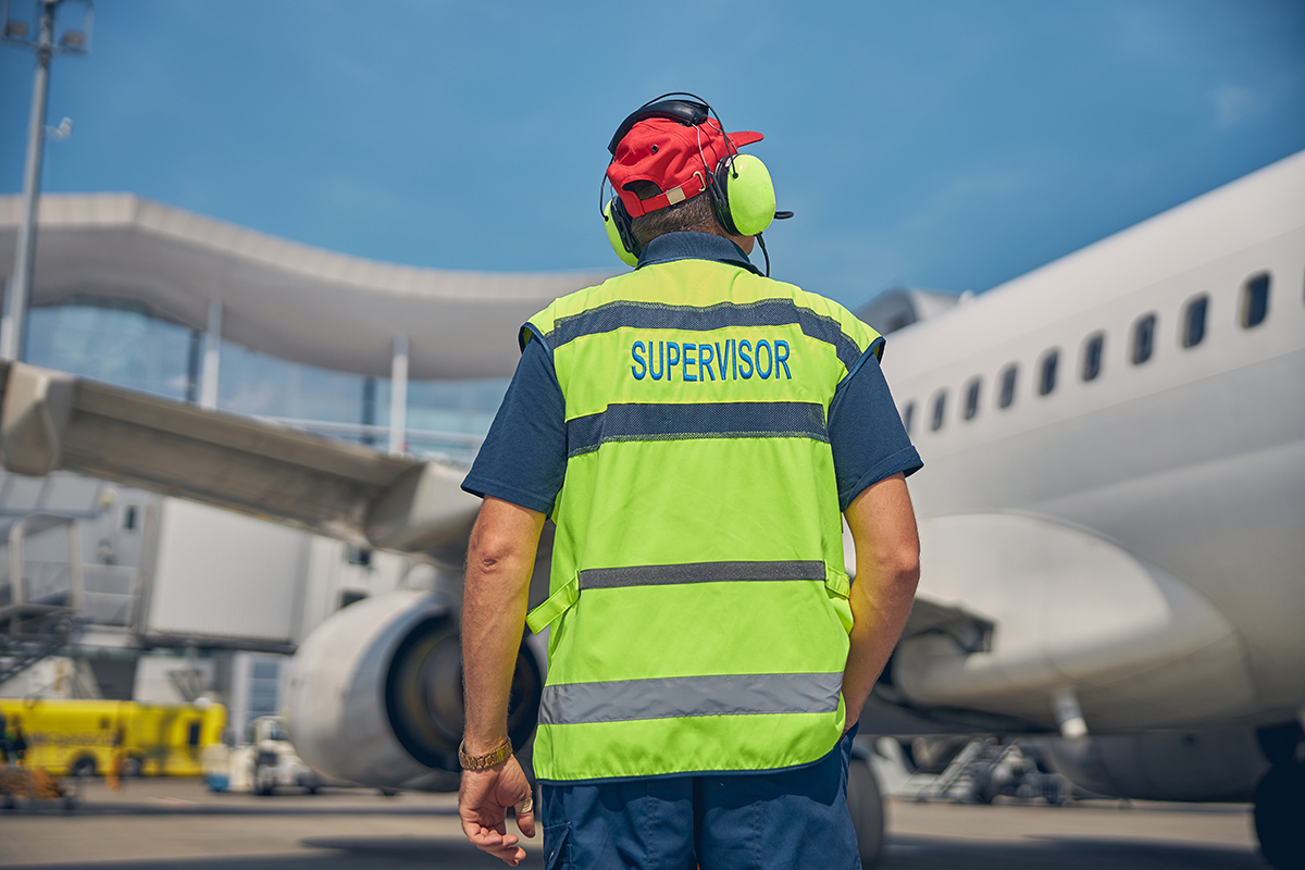 supervisor wearing noise-canceling headset in an airport