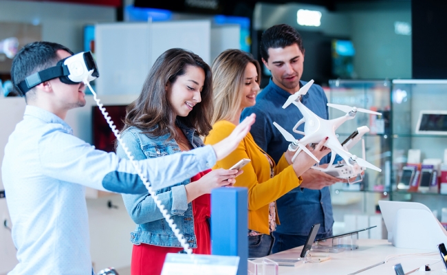 young people testing and buying latest electronics