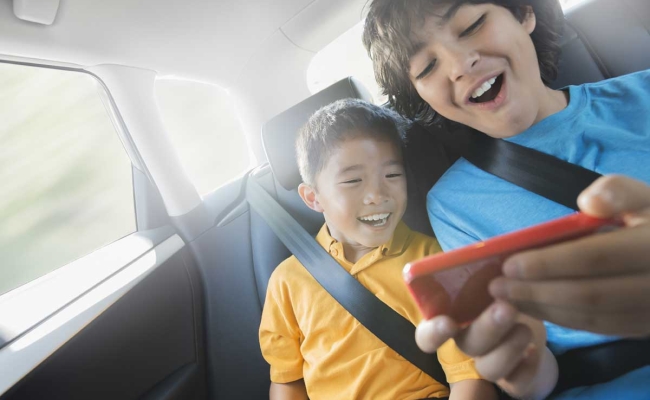 Two boys with handheld gaming console