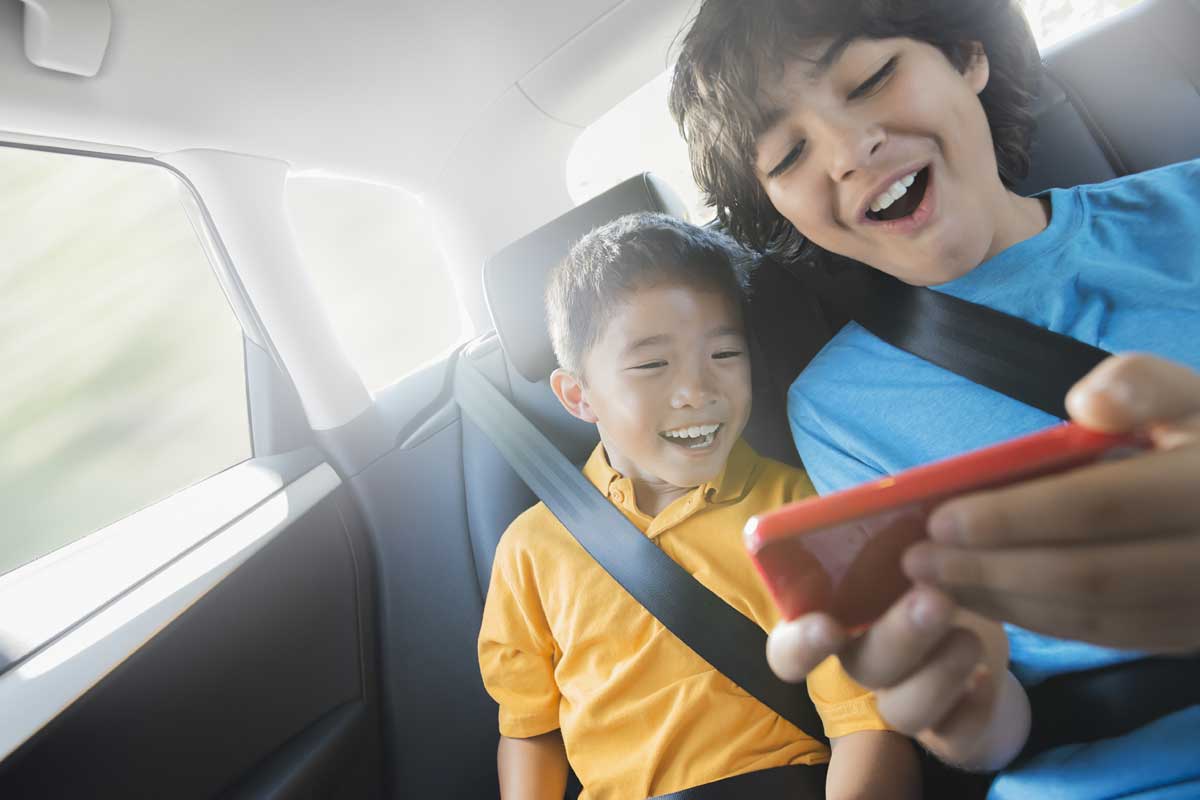 Two boys with handheld gaming console