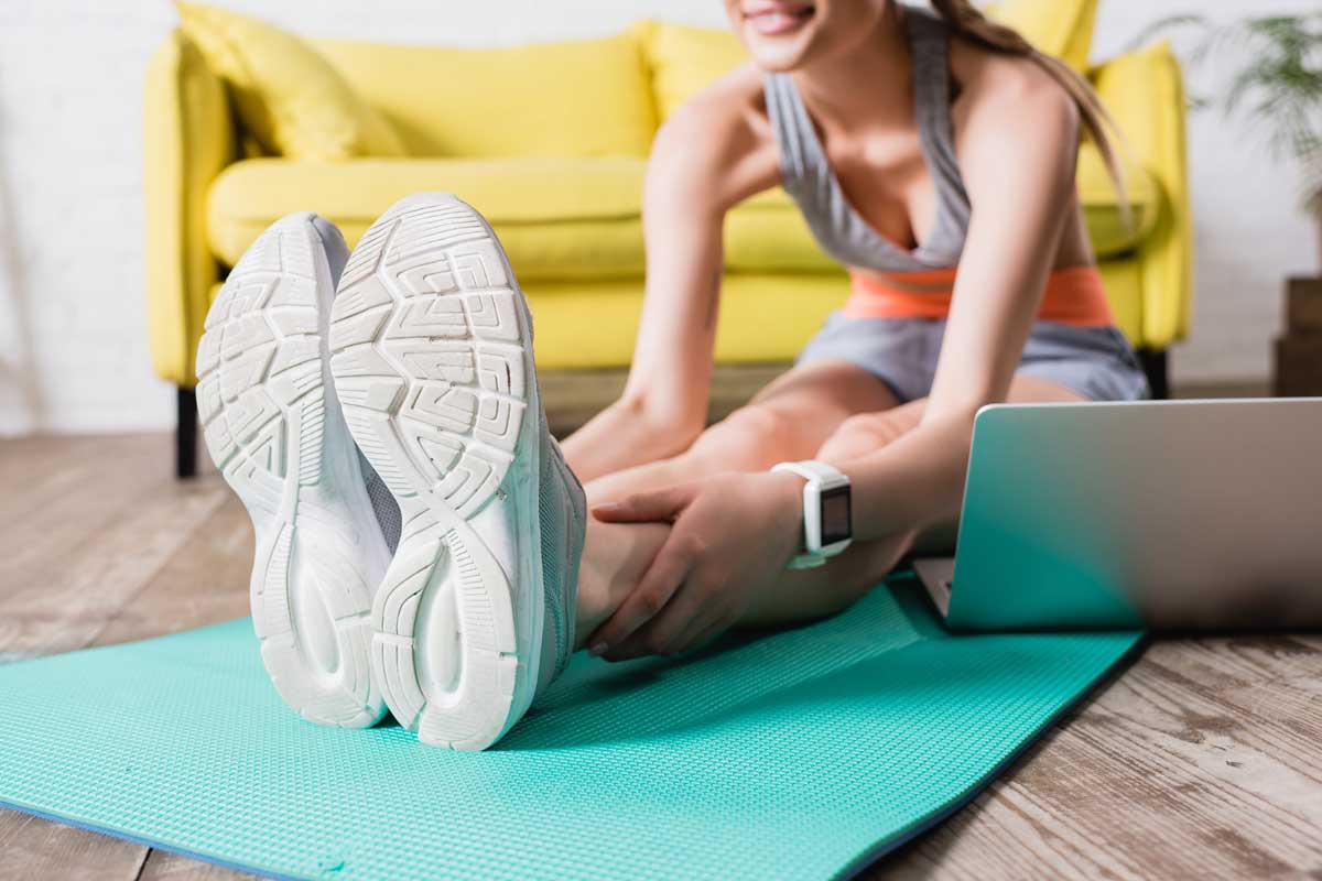 Woman stretching on yoga mat