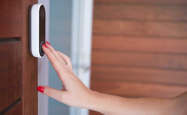 Woman ringing video doorbell