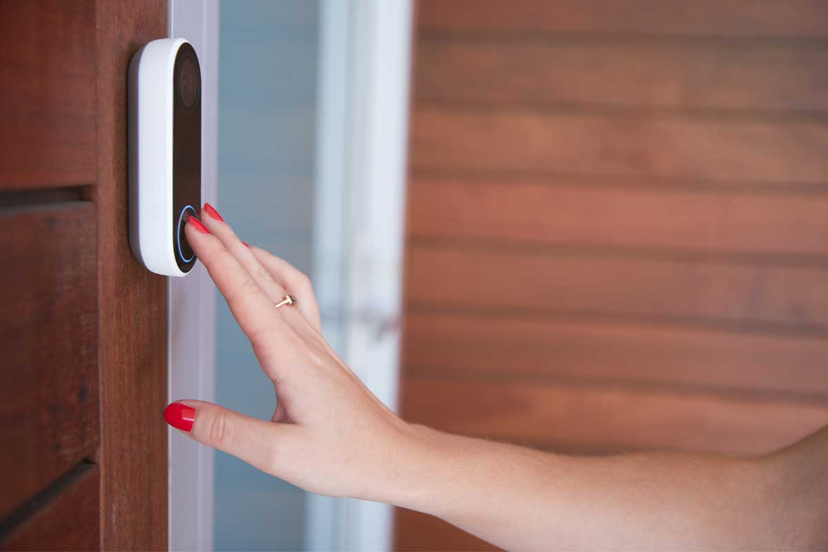 Woman ringing video doorbell