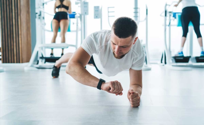 Man at gym with fitness tracker