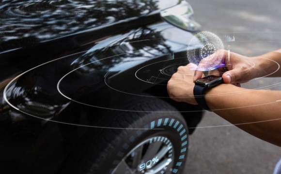 Man using smart watch to check car air pressure
