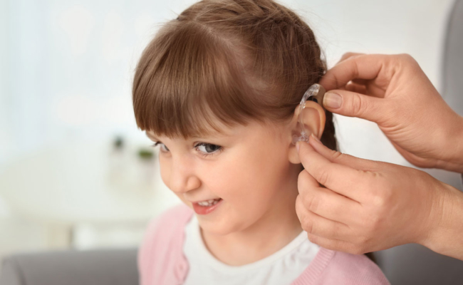 Child receiving smart hearing aid