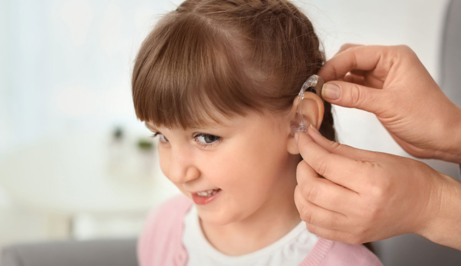 Child receiving smart hearing aid