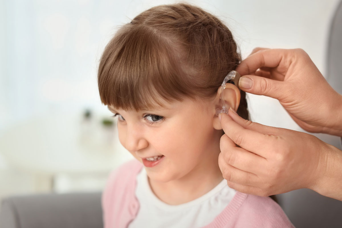 Child receiving smart hearing aid