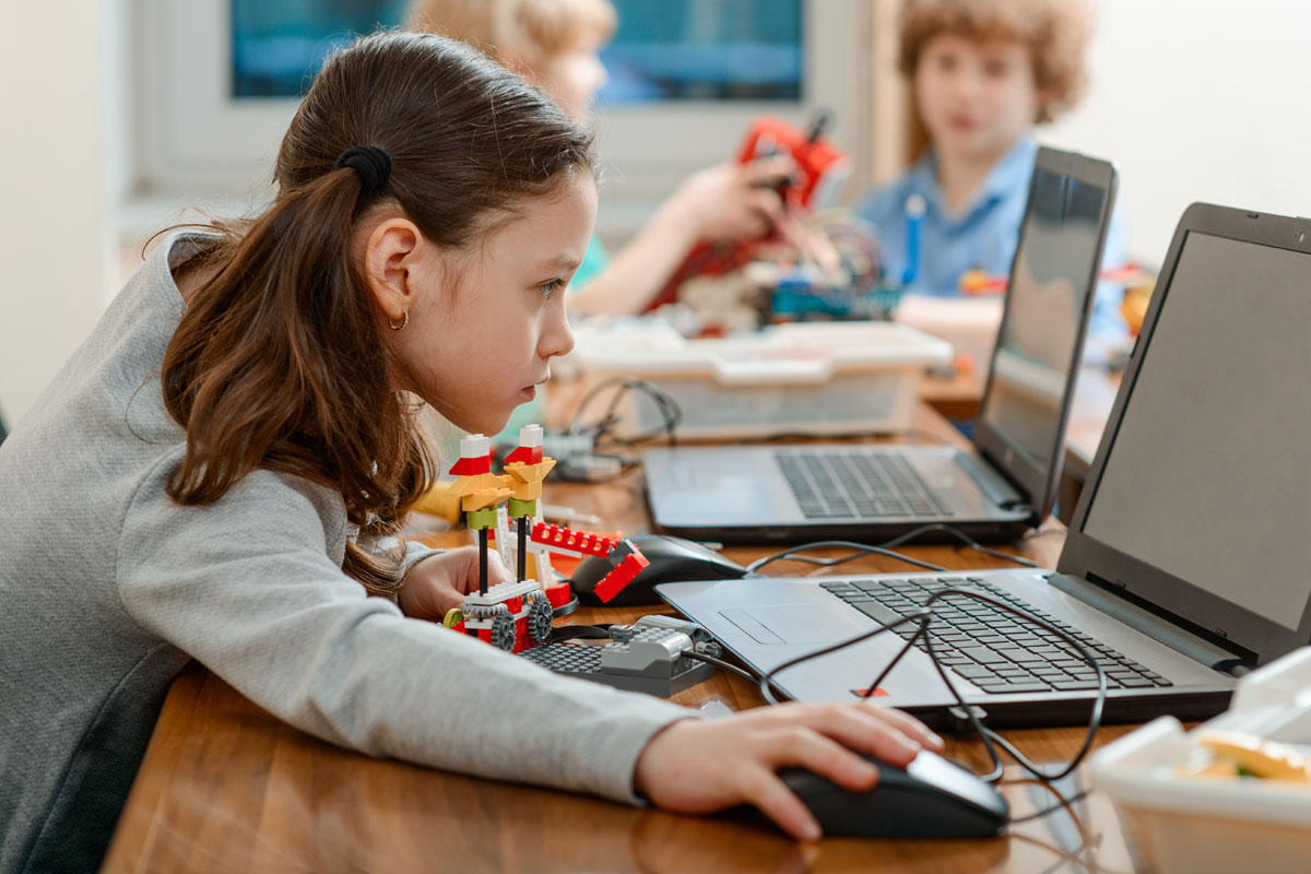 Girl assembling robot with STEM