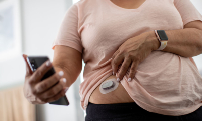 Woman using glucose monitoring system