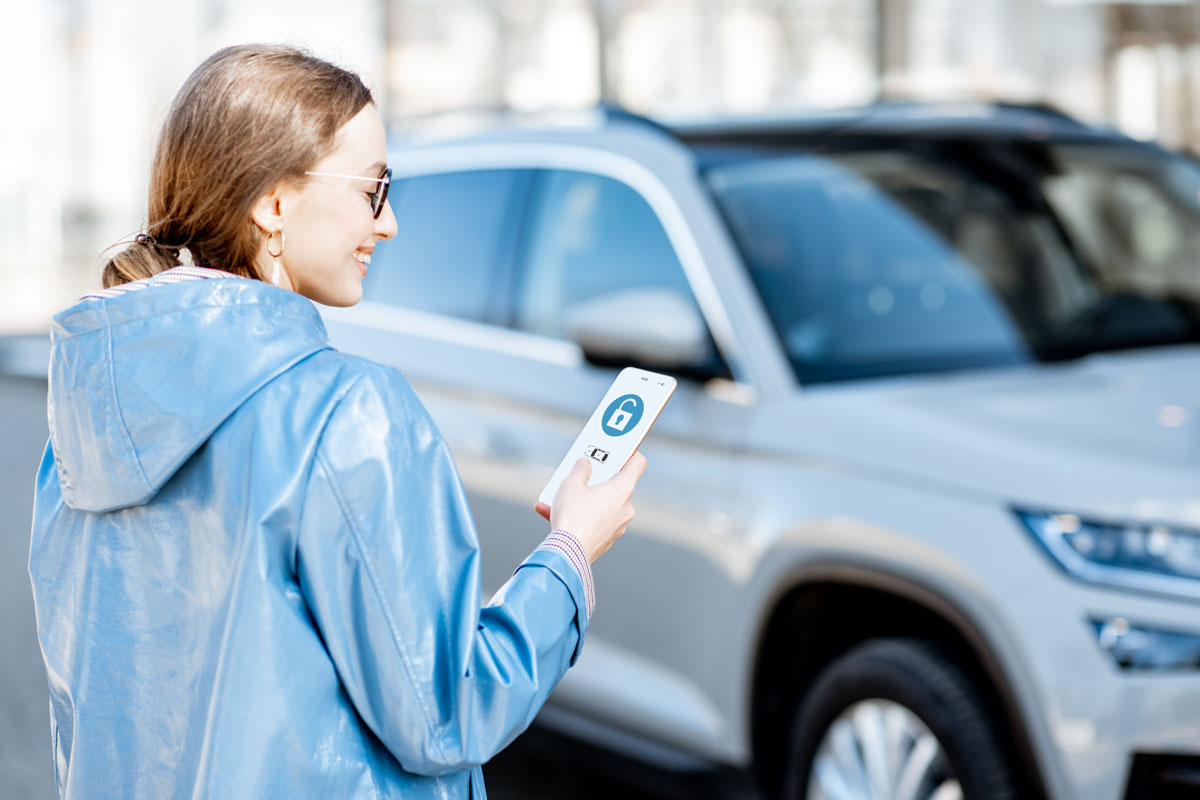 Woman using mobile device to unlock car