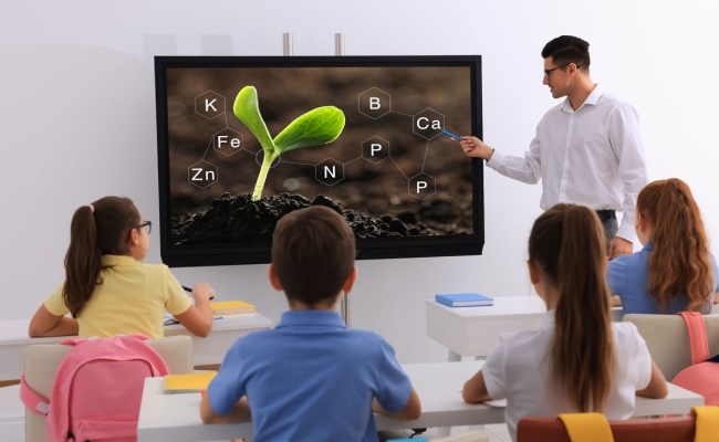 Teacher using smart board in classroom