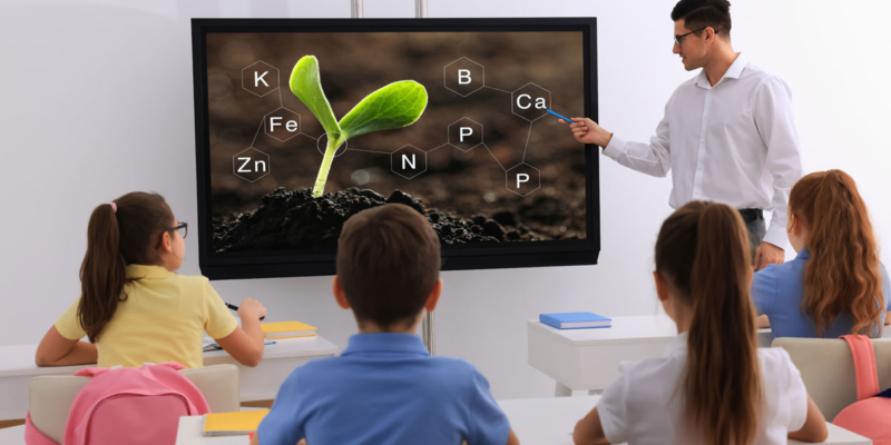 Teacher using smart board in classroom