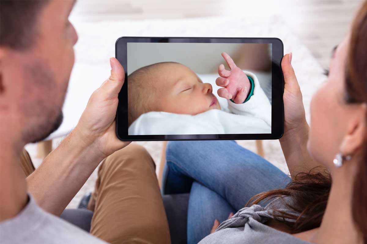How-AI-and-IoT-Is-Revolutionizing-Childcare---baby-on-tablet