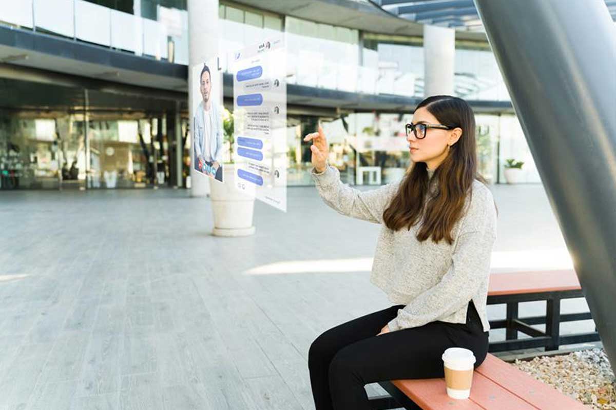 Smart-Glasses-are-Going-Next-Gen-with-AI Blog---Woman-sitting-down-wearing-AR-Glasses